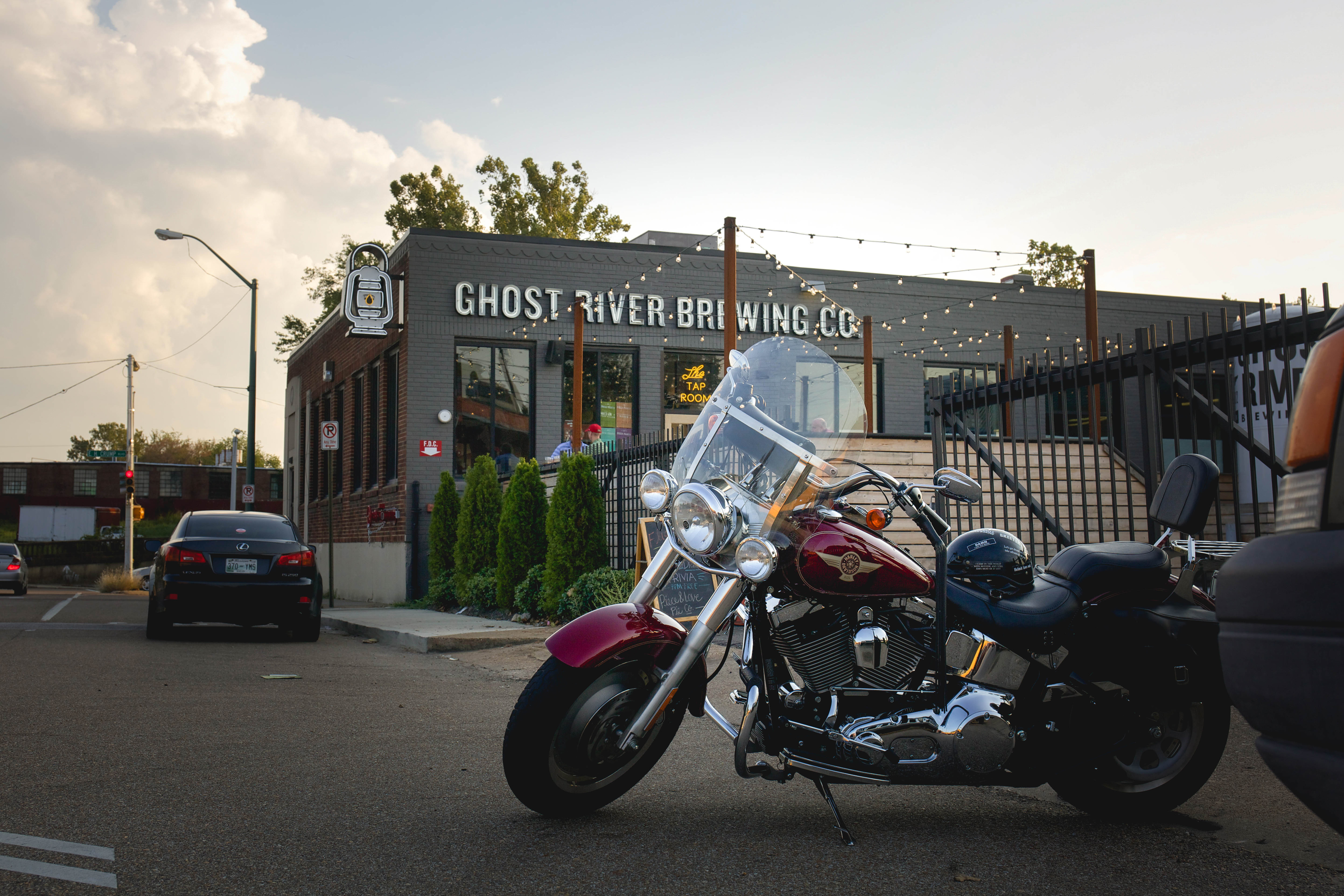 motorcycle sitting out front of ghost river brewing building