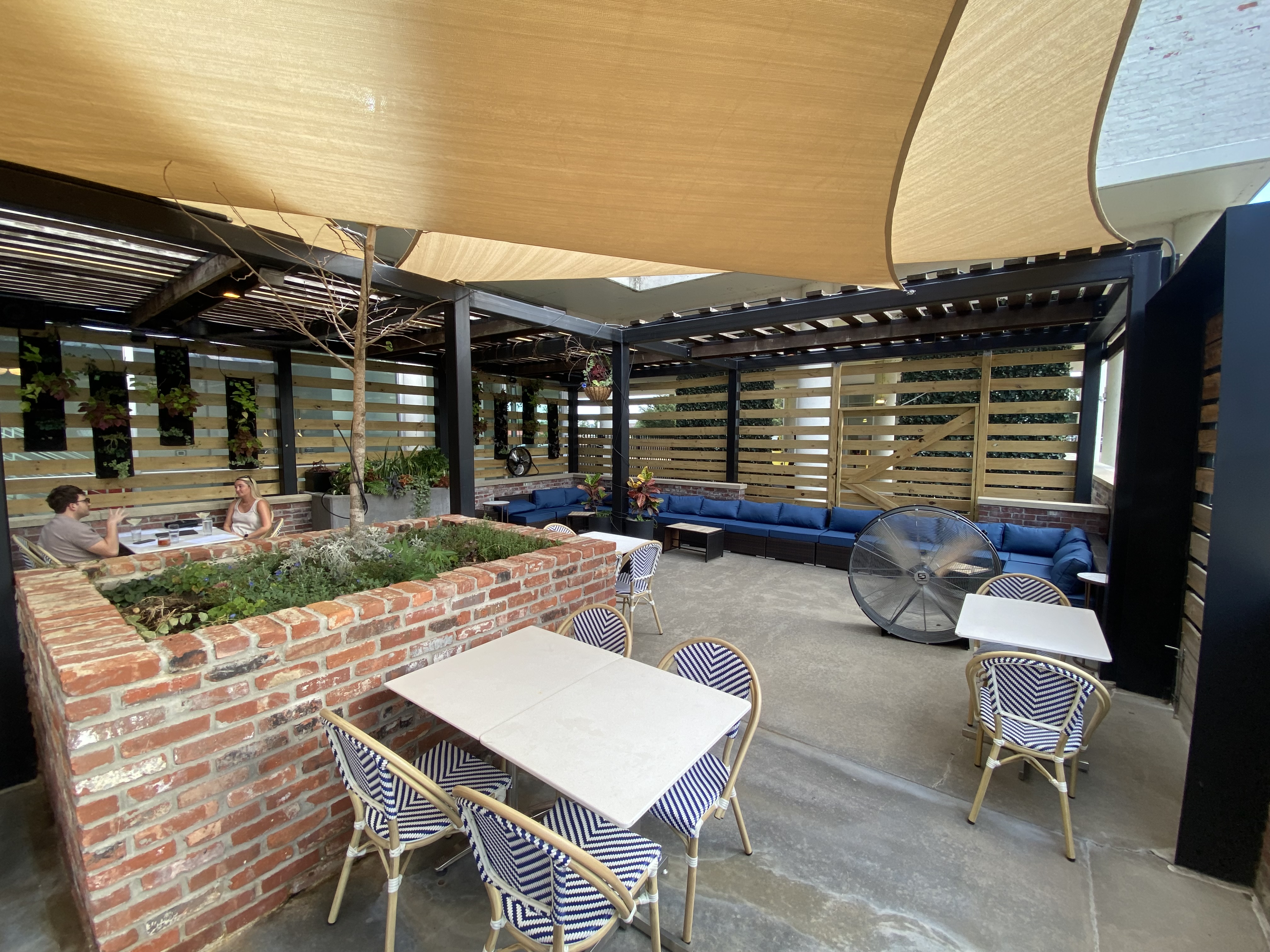 lobbyist patio with shaded canopies, tables, and lounge couches