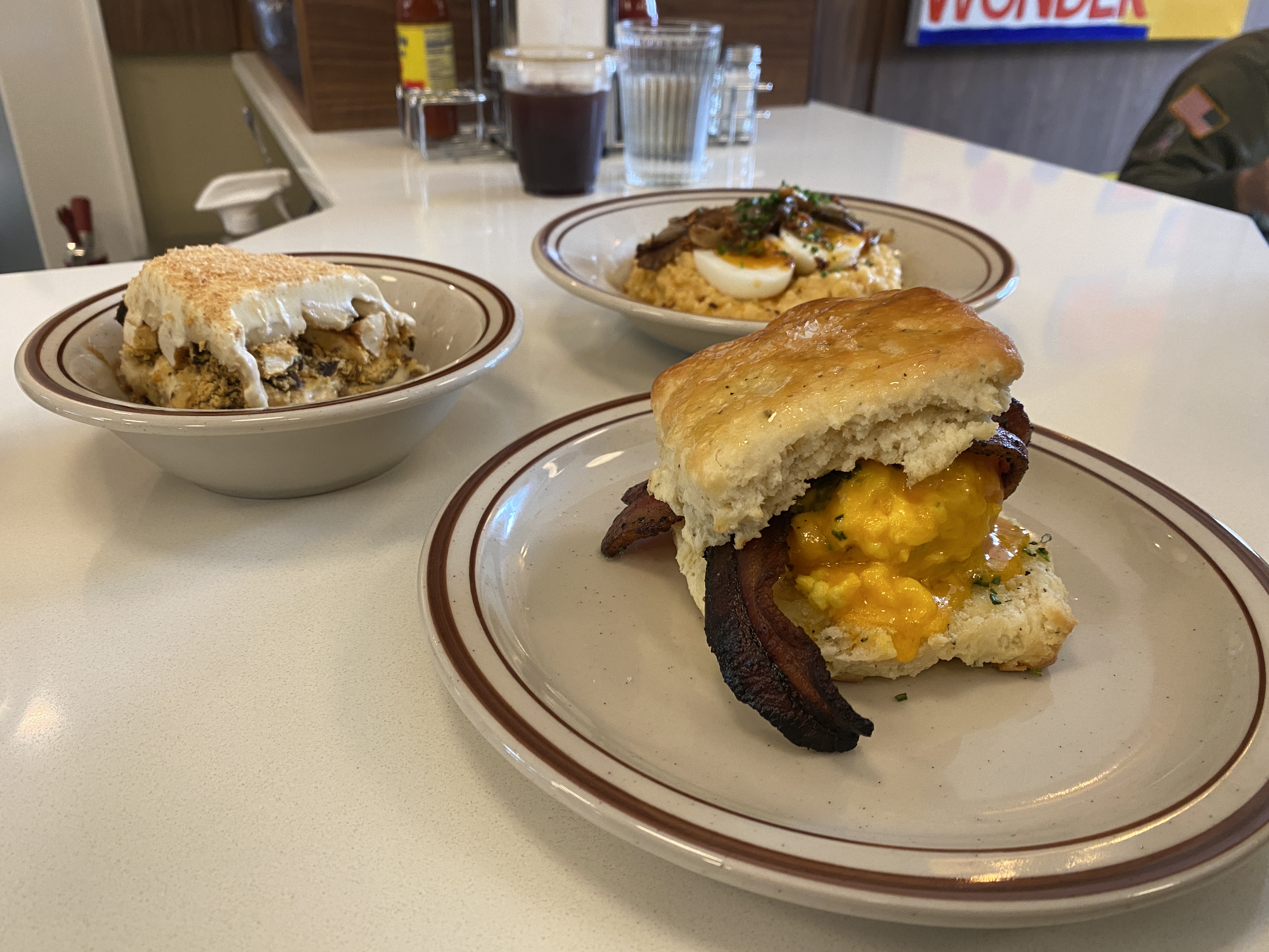 bacon egg and cheese biscuit, grits, and tiriamsu 