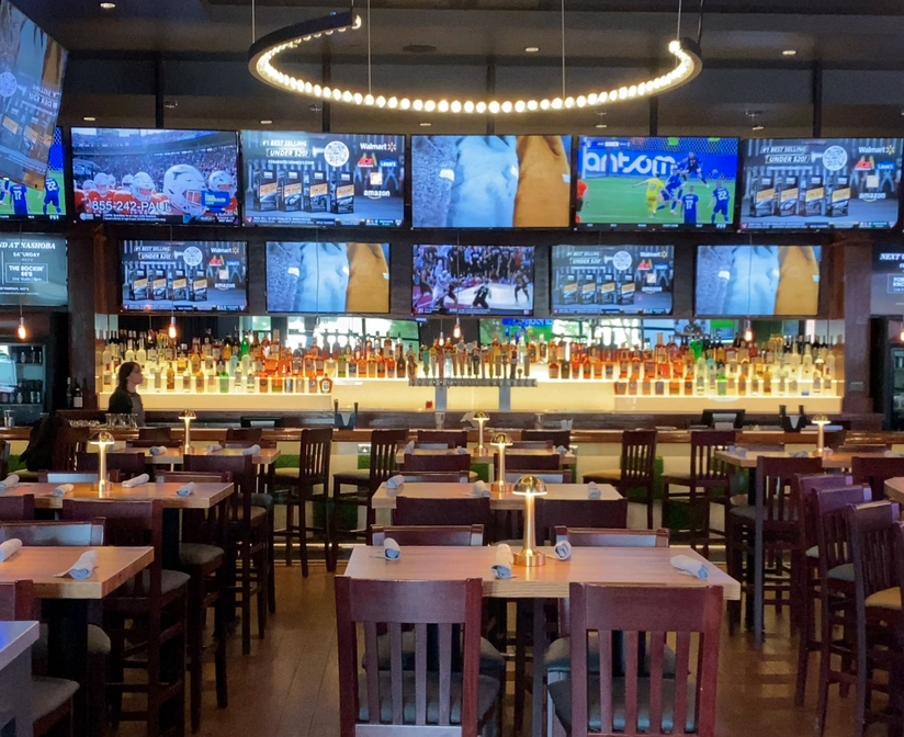 inside Nashoba bar with view of the bar and numerous TVs