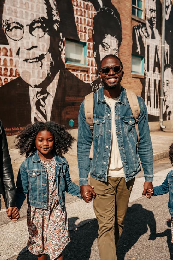 family of four in front of Upstanders civil rights mural 