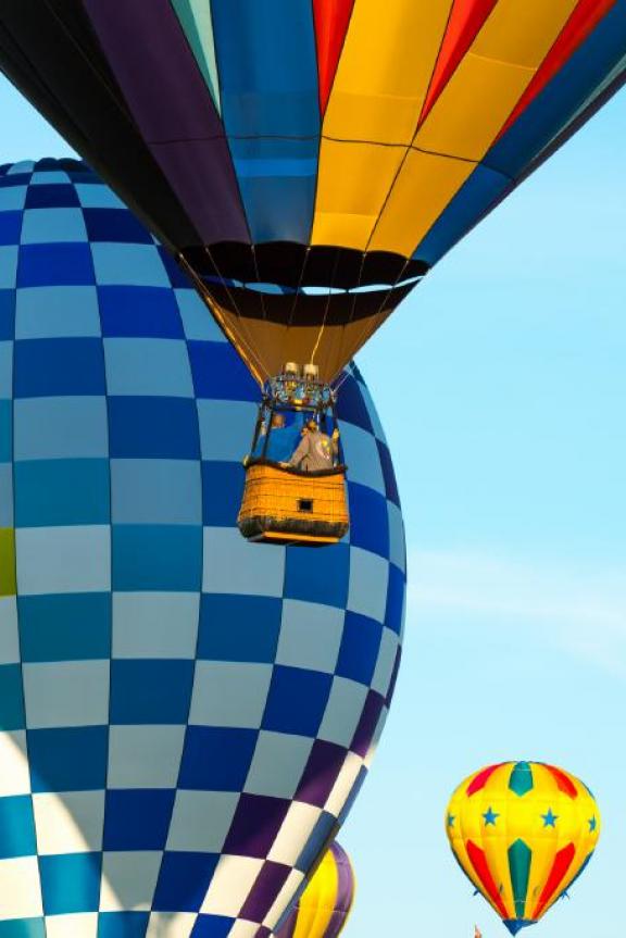 colorful hot air balloons floating through blue sky