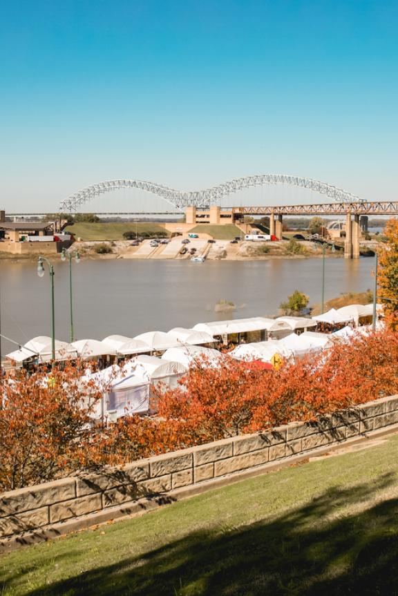 Riverside Dr. with tents for RiverArtsFest with the Hernando de Soto "M" bridge in the background.
