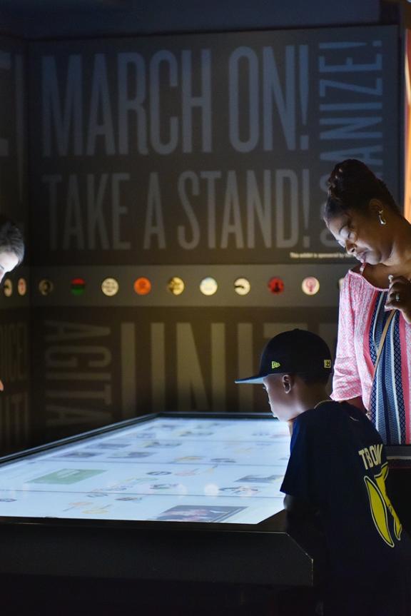 Visitors around an interactive smart table at the National Civil Rights Museum.