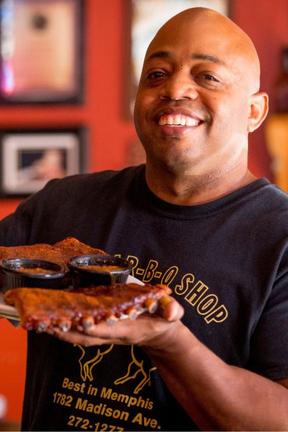 Owner Eric Vernon showcases a platter of ribs at his Midtown Memphis restaurant, The Bar-B-Q Shop