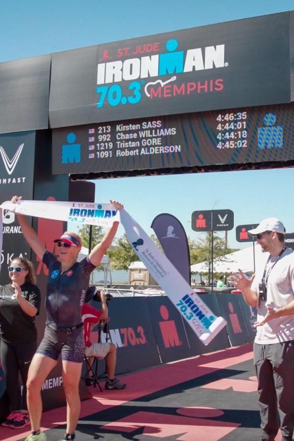 A competitor crosses the finish line of the St. Jude IRONMAN 70.3 Memphis