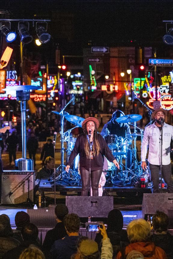 A band performs a concert outside at night on Beale Street in Memphis, Tennessee