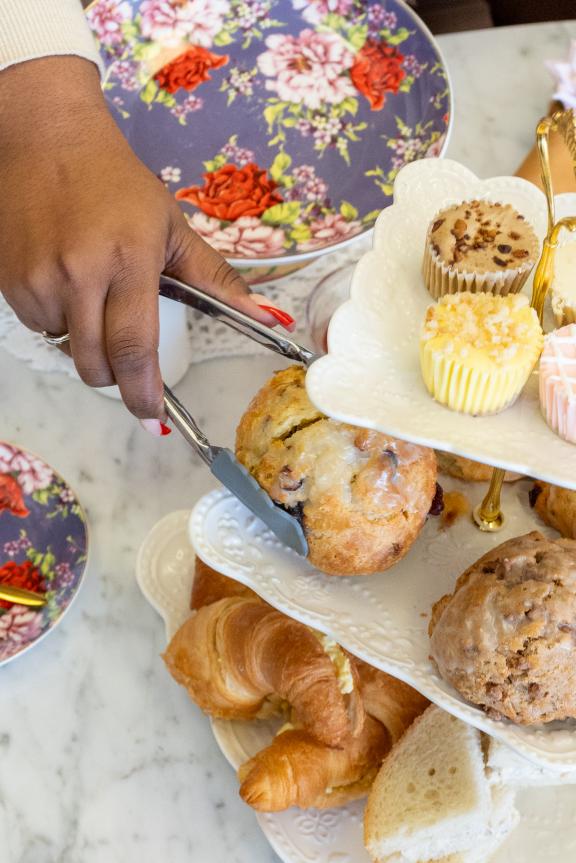 afternoon tea setup with tea pots and treats