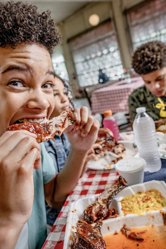 boy eats rib at payne's