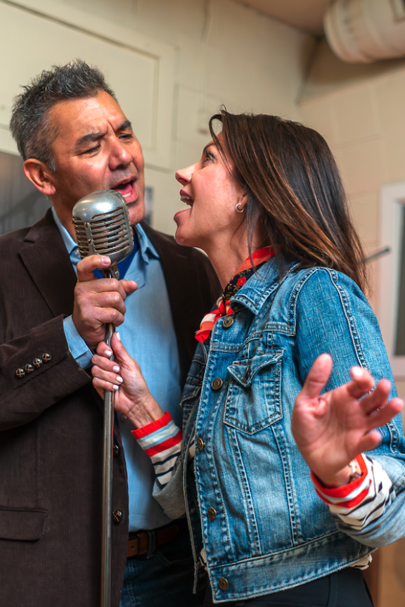 couple sings into mic at sun studio