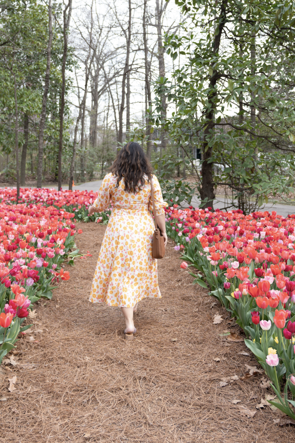 woman walks through tulips