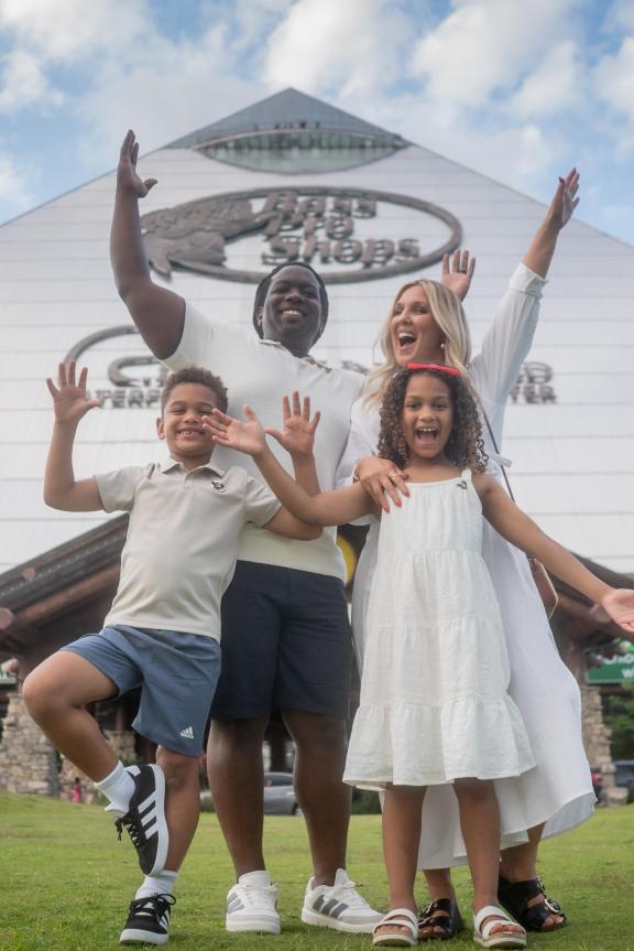 family poses in front of bass pro pyramid