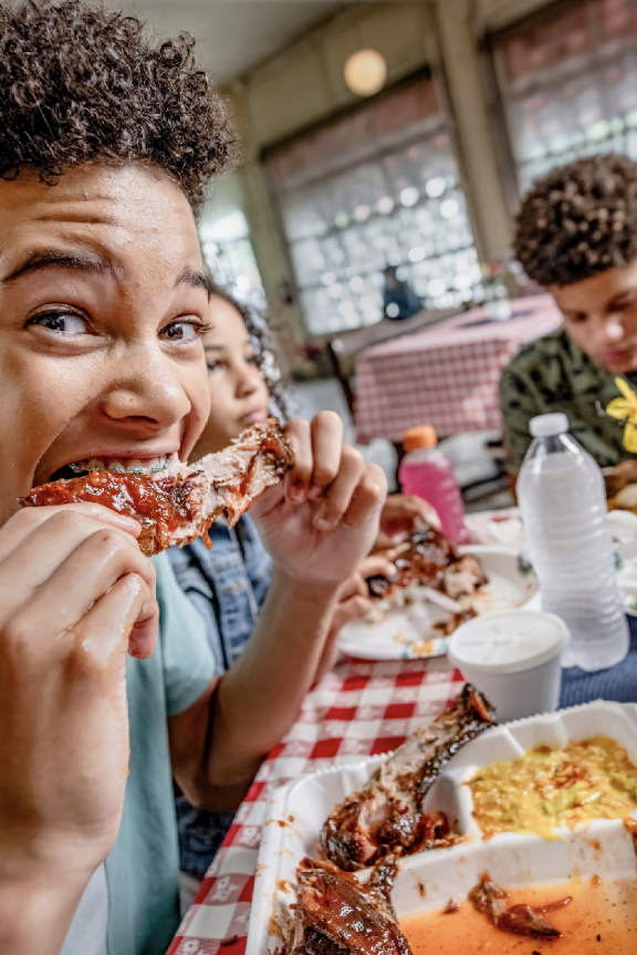 teen eating ribs from Paynes