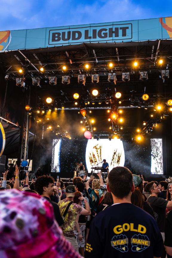 crowd's view looking at stage during concert with giant beach balls in air