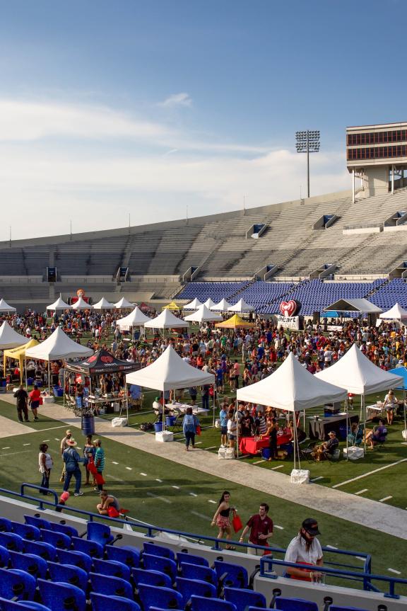 aerial photo of stadium filled with tents for chicken and beer festival