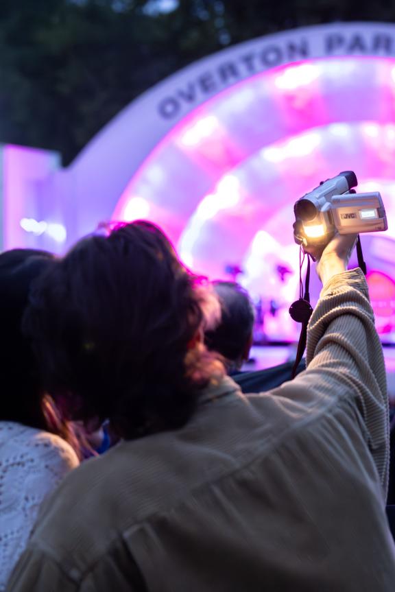 couple poses for photo while watching a concert at overton park shell