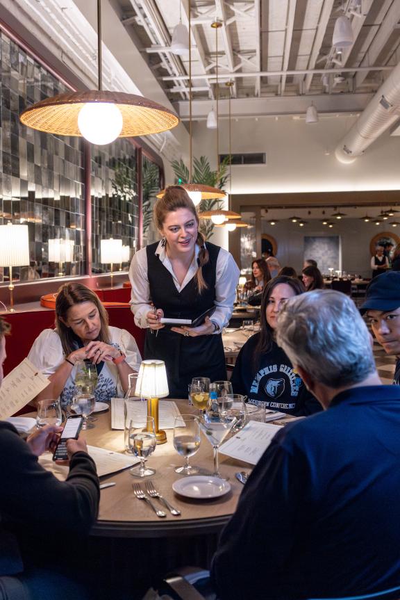 Waitress takes order at table inside Felicia Suzanne's dining room.