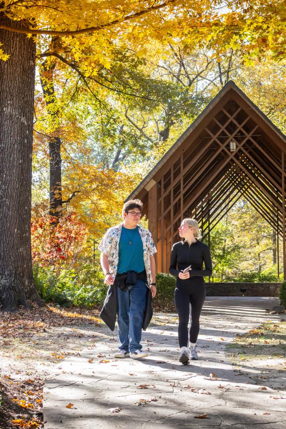 a couple walks through Memphis Botanic Garden during the fall foliage