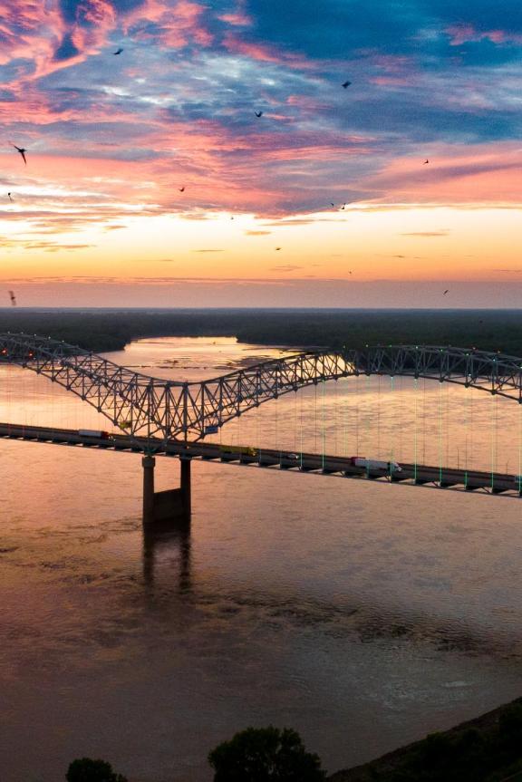 Hernando de Soto bridge over the Mississippi River at sunset.