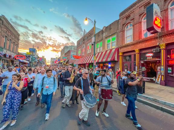 Conference and band marching on Beale Street