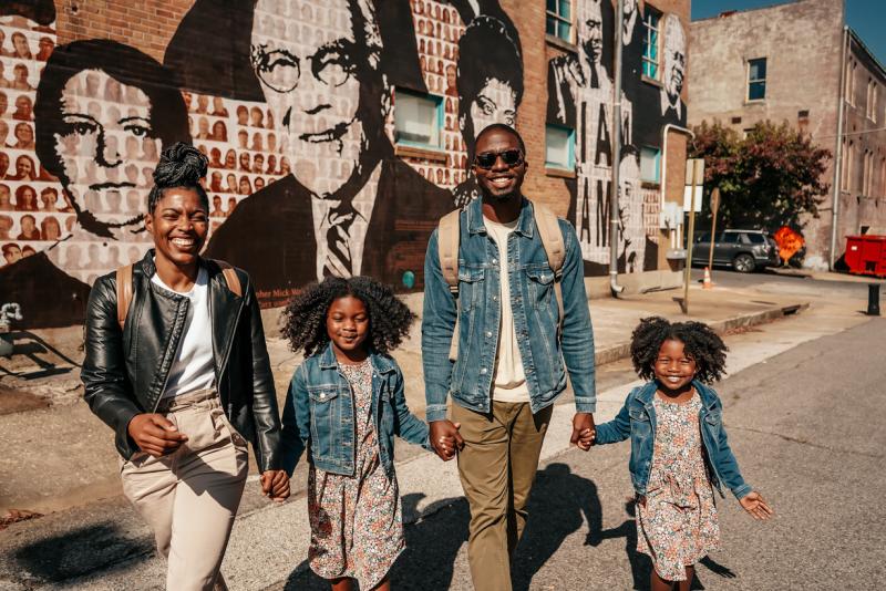 family of four in front of Upstanders civil rights mural