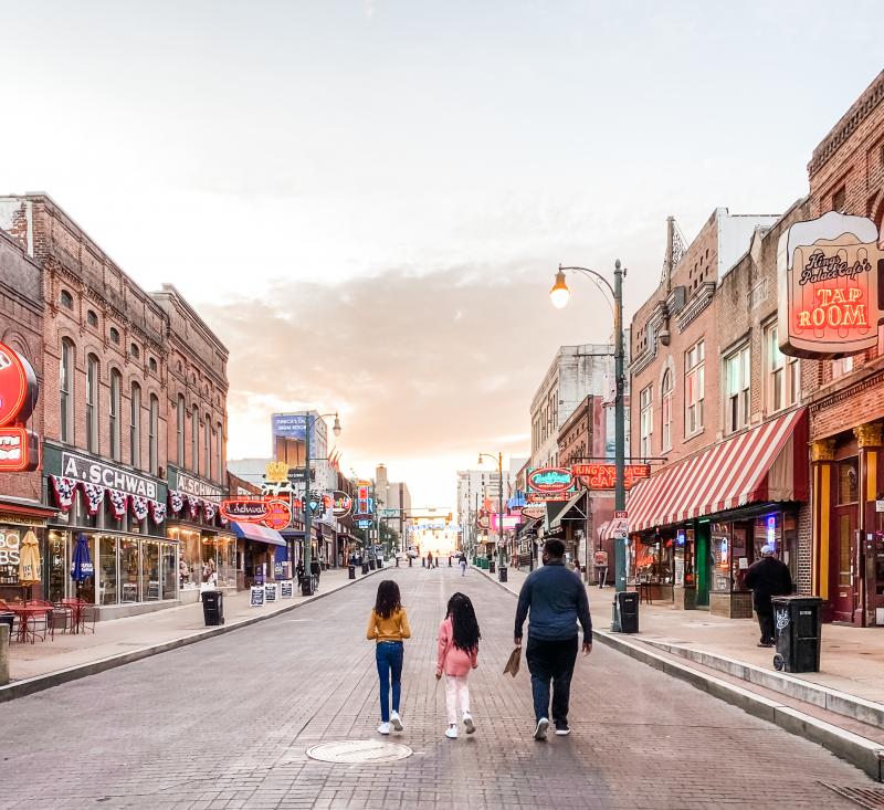 Family strolling Beale Street at sunset