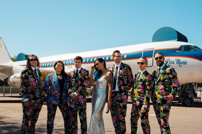Wedding party poses in front of Elvis' private plane, the Lisa Marie