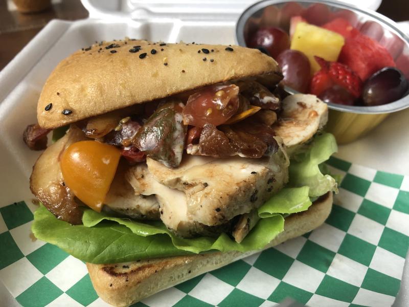 a tall grilled chicken sandwich on ciabatta with tomato salsa