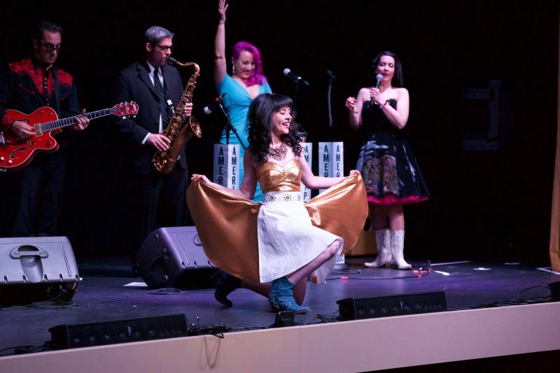A woman does a curtsy during the Ameripolitan Fashion Show