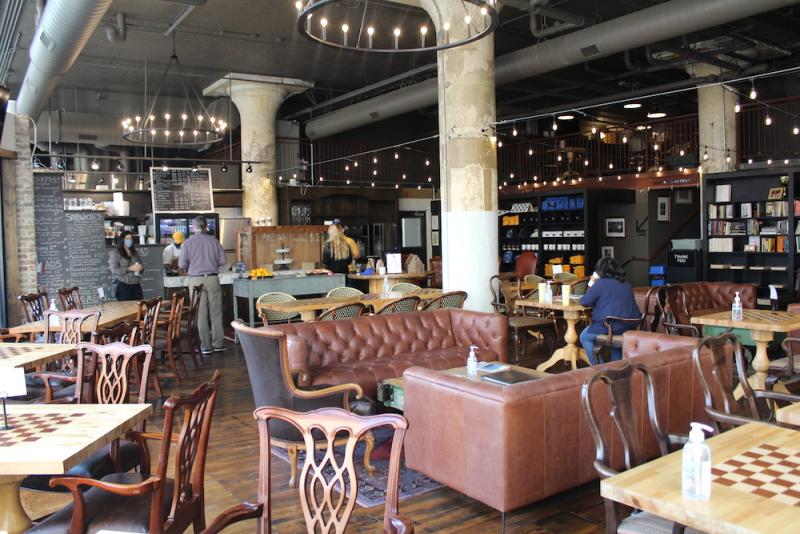 Interior of Memphis Chess Club coffee shop with leather coaches and cheer tables