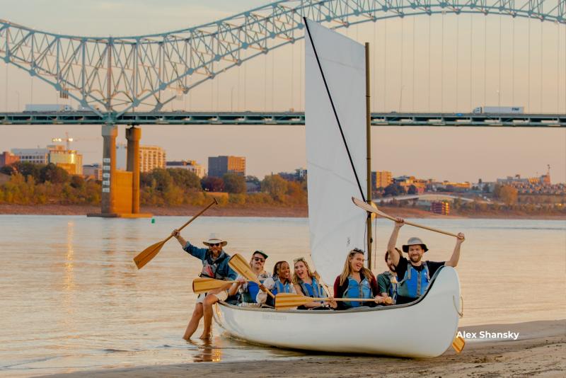 Canoers posing for a picture with paddles on the Mississippi River