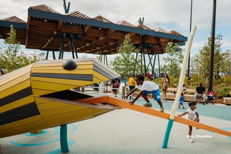 Kids climbing on animal structures at the playground at Tom Lee Park