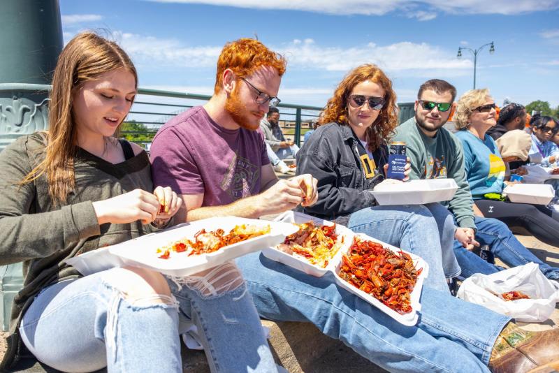 Friends dig into crawfish at Rajun Cajun Crawfish Festival.