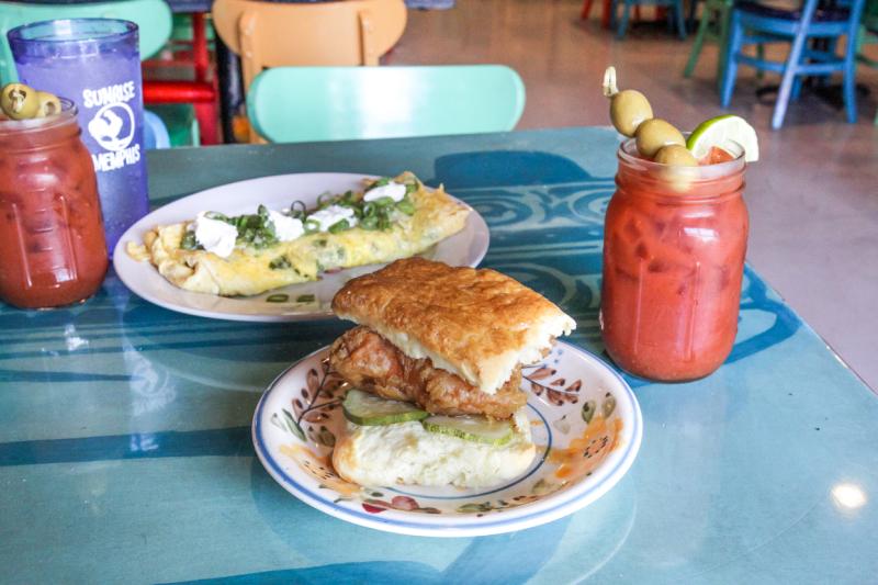 Plate of biscuits, a cler glass of red bloody mary drink