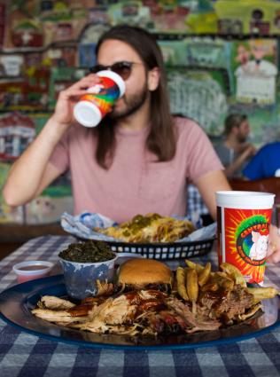 Visitor enjoying barbecue at Central BBQ.