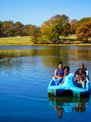 Family paddle boating at Shelby Farms Park. 