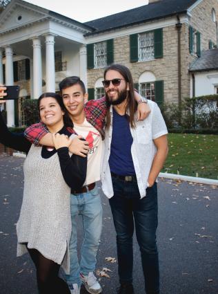 family poses for photo outside graceland