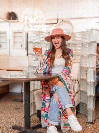 woman poses for photo at beauty shop restaurant