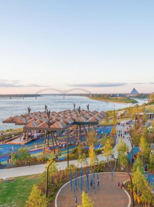 Aerial view of Tom Lee Park on the banks of the Mississippi River with the Hernando de Soto Bridge and Memphis skyline in the background.