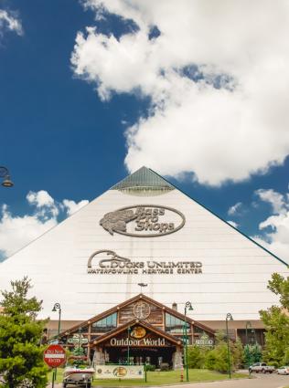 Exterior view of Bass Pro Pyramid with clouds in the background, photo by Alex Shansky