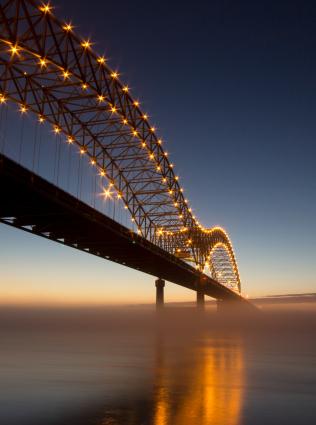 View of Hernando de Soto bridge over the Mississippi River at sunset, photo by John Bell