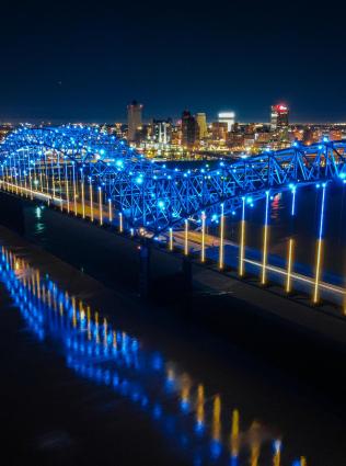 Aerial view of Hernando de Soto bridge at night, photo by Logan Schaal