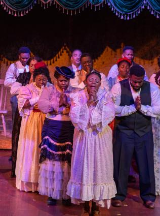 Performers on stage during a play at Hattiloo Theatre.