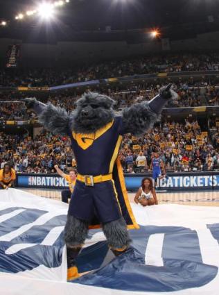 grizzlies mascot stands on court in front of crowd