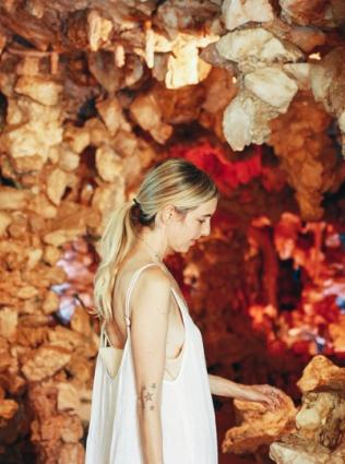 A woman inside the Crystal Shrine Grotto, walled with gem-like formations, at Memphis' Memorial Park Cemetery