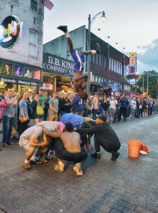 Beale Street Flippers vaulting over a group on Beale.