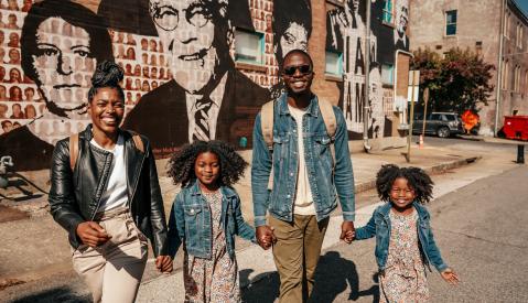 Family in front of National Civil Rights Museum mural  