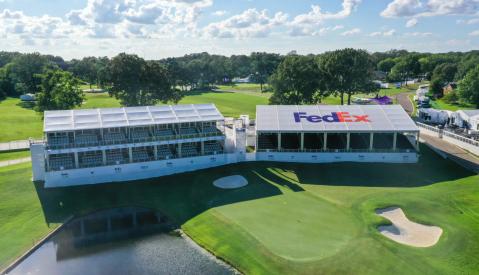 aerial shot of golf course with Fedex bleachers/booths next to hole