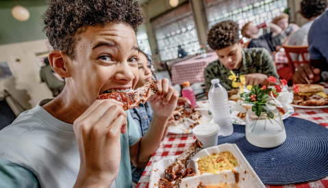 boy eats rib at payne's