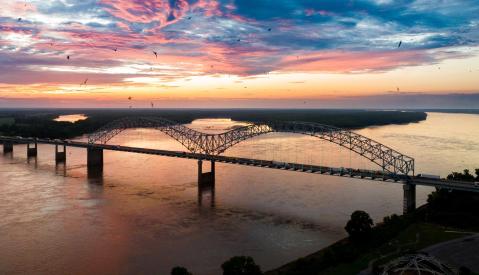 Hernando de Soto bridge over the Mississippi River at sunset.